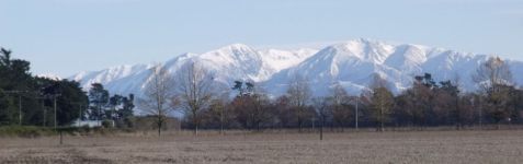 Canterbury farmland early in winter, back-grounded by foothills of Southern Alps lightly dusted in snow. New Zealand, June 2015.